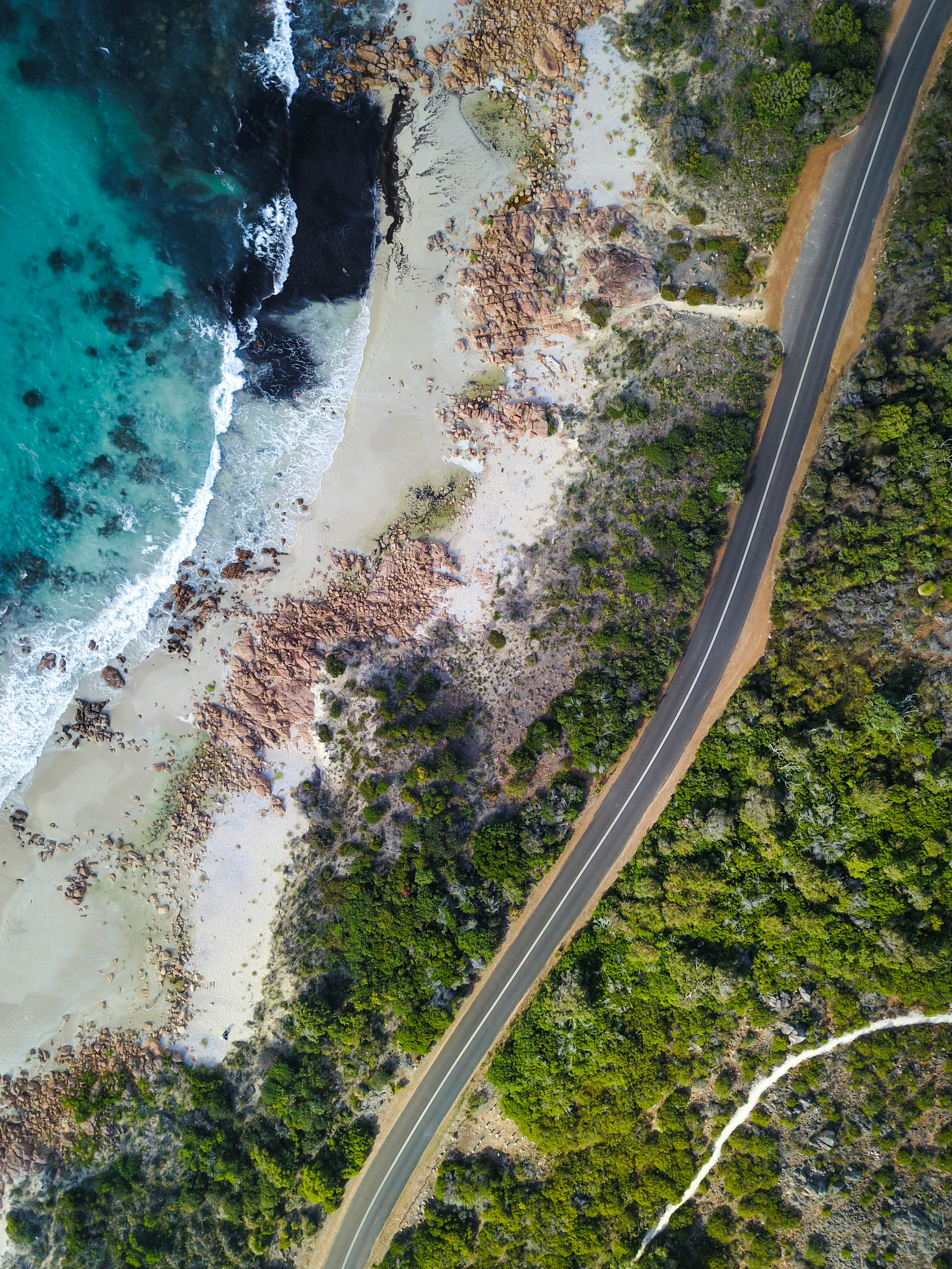 aerial view of road beside the seashore